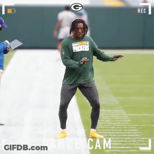 A Green Bay Packers Football Player Is Dancing On The Field GIF