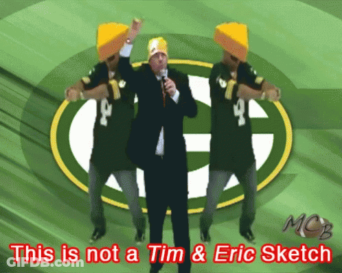 A Green Bay Packers Logo Is Behind A Man In A Suit GIF