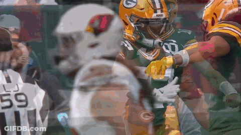 A Green Bay Packers Player Is Being Tackled By Another Player GIF