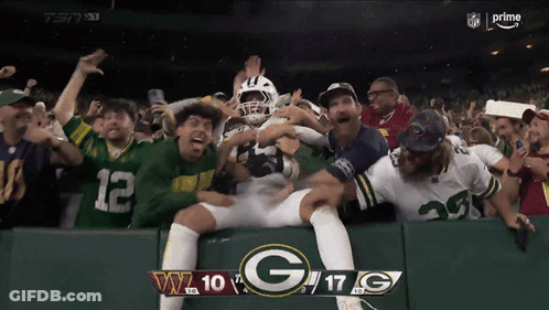 A Green Bay Packers Player Is Surrounded By Fans During A Football Game GIF