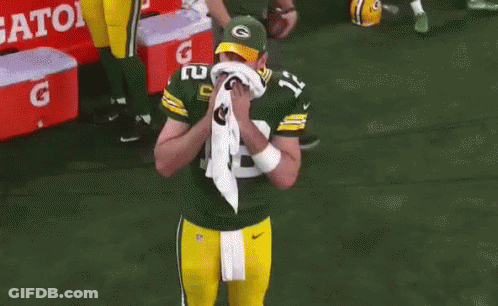 A Green Bay Packers Player Wipes His Face With A Towel GIF