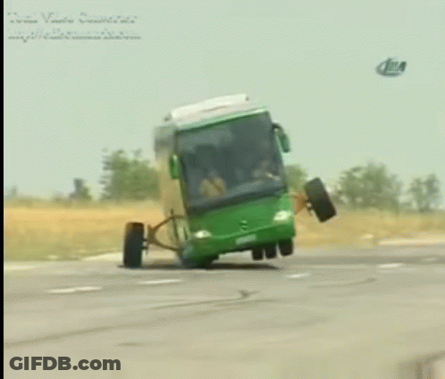 A Green Bus With A Broken Wheel Is Driving Down A Highway GIF