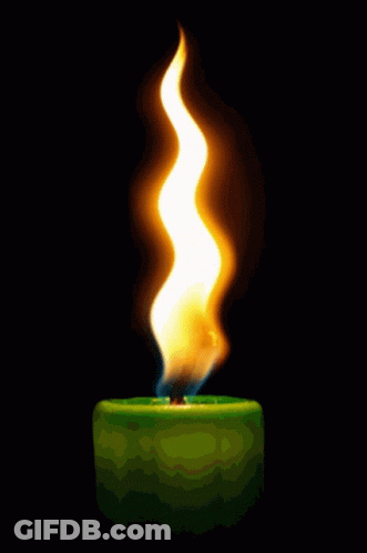 A Green Candle With A Yellow Flame On It GIF