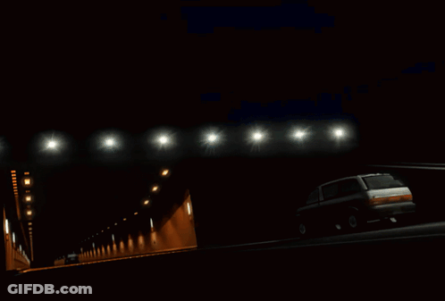 A Green Car Is Driving Through A Tunnel With A Sticker On The Windshield That Says ' Adia ' On It GIF