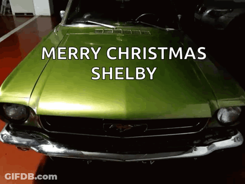 A Green Car With The Words Merry Christmas Shelby On The Hood GIF