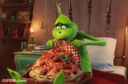 A Green Cartoon Character Is Eating Spaghetti And Meatballs GIF