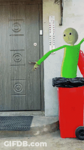 A Green Cartoon Character Is Standing Next To A Red Garbage Can GIF