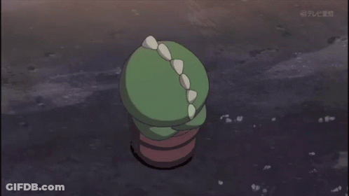 A Green Cartoon Character With Spikes On Its Head Is On A Television Screen GIF
