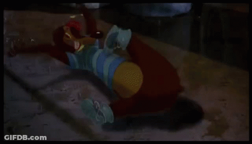 A Green Cartoon Character With Wings Is Laying On The Floor . GIF
