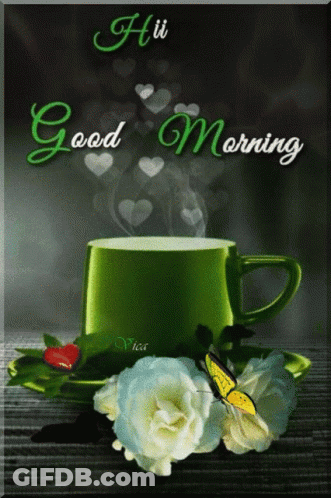 A Green Cup Of Coffee Sits On A Saucer Next To Flowers GIF