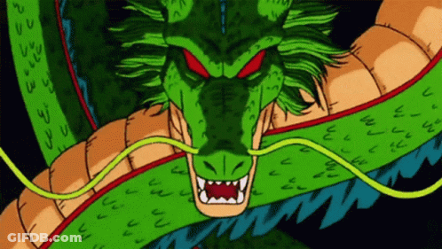 A Green Dragon With Red Eyes And Sharp Teeth Looks At The Camera GIF