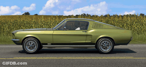A Green Ford Mustang Is Parked On The Side Of The Road GIF