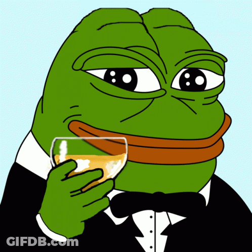 A Green Frog In A Tuxedo Is Holding A Glass Of Orange Liquid GIF
