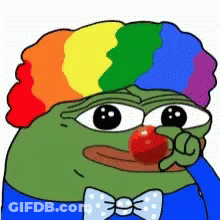 A Green Frog Wearing A Rainbow Wig And A Bow Tie Is Holding A Red Nose . GIF