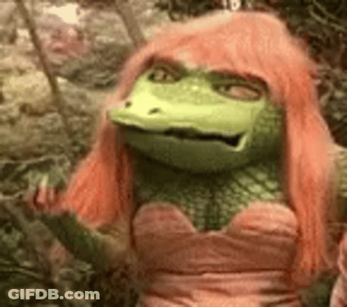 A Green Frog With Pink Hair Is Wearing A Pink Dress And Giving The Middle Finger . GIF