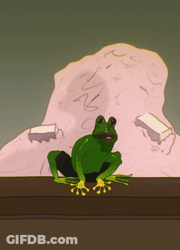 A Green Frog With Yellow Claws Sits On A Table GIF