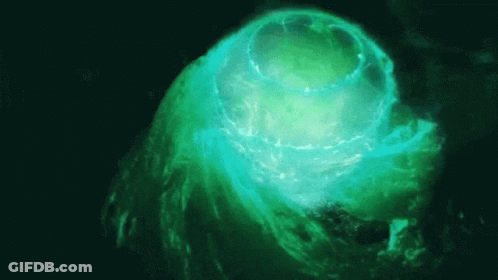 A Green Glowing Object In The Dark GIF