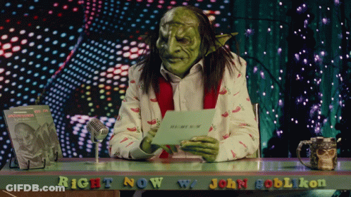 A Green Goblin Is Sitting At A Desk With The Words Right Now W/ John Goblikon GIF