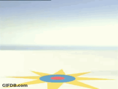 A Green Gummy Bear In A Diaper Is Dancing On A Blue And Yellow Circle . GIF