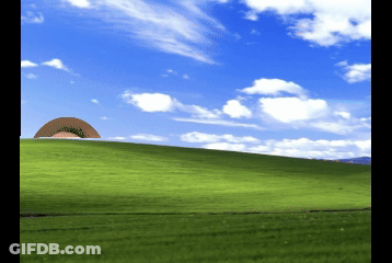 A Green Hill With A Blue Sky And White Clouds GIF