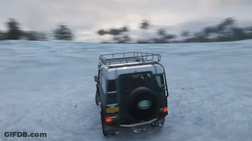 A Green Land Rover Driving Through The Snow GIF