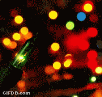 A Green Light Is Lit Up In Front Of A Bunch Of Colorful Lights GIF