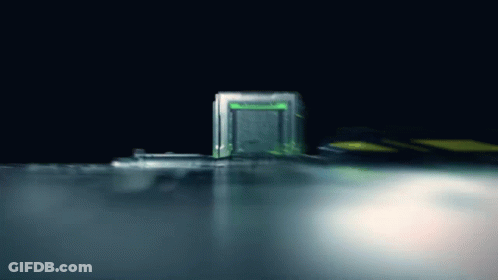 A Green Light Is Shining On A Dark Background GIF