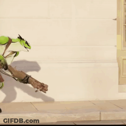 A Green Lizard Is Holding A Gun In Its Hand GIF
