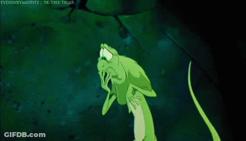 A Green Lizard Is Standing In The Dark With Its Arms Outstretched And A Caption That Says Fydisneymisfits GIF