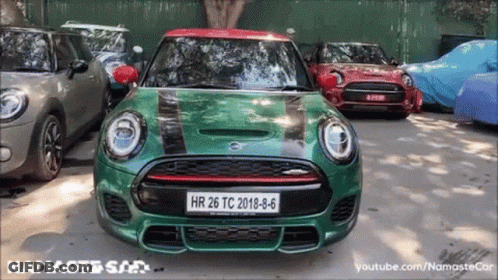 A Green Mini Cooper With A License Plate That Says Hr 26 Tc 2018-8-6 GIF