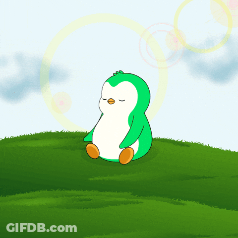 A Green Penguin Sits On A Grassy Hill With Its Eyes Closed GIF