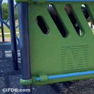 A Green Playground With A Blue Railing And A Green Fence With The Letter M On It GIF