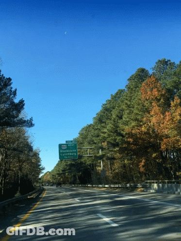 A Green Sign On The Side Of A Highway Shows The Directions To Strawberry GIF