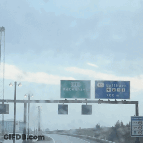 A Green Sign That Says E20 Kobenhavn GIF