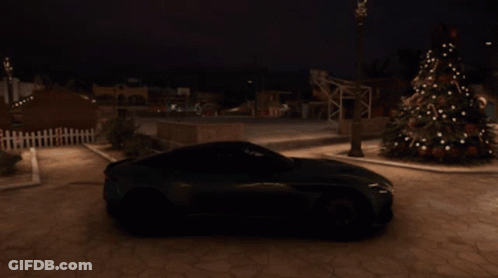 A Green Sports Car Is Parked Near A Christmas Tree GIF