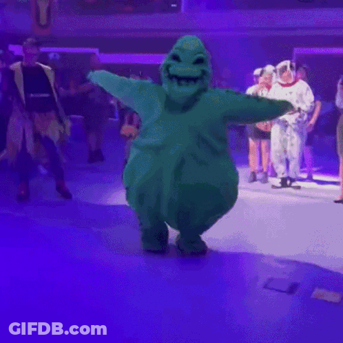 Green Stuffed Animal Dancing On Stage GIF