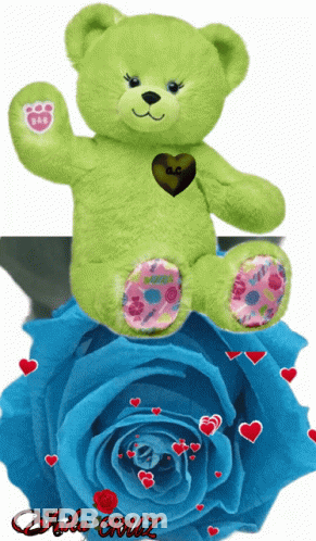 A Green Teddy Bear Sits On Top Of A Blue Rose With Hearts Around It GIF