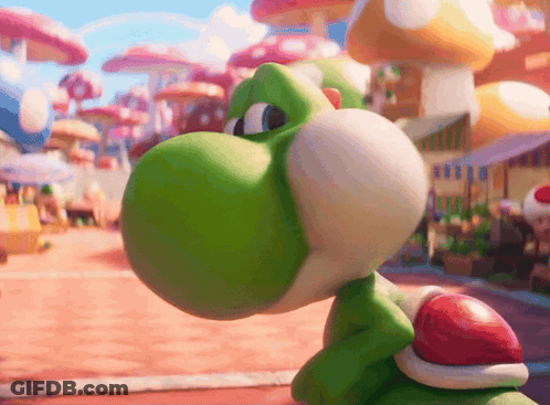 A Green Toy With A Red Shell On Its Back Is Looking At Something GIF