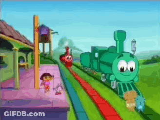 A Green Train With A Face On It Is Going Down A Train Track GIF
