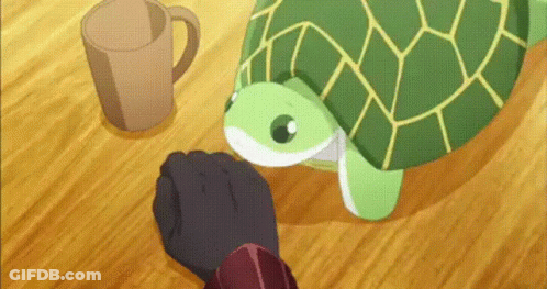 A Green Turtle Is Sitting On A Wooden Table Next To A Cup . GIF