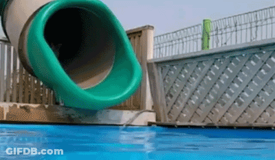 A Green Water Slide Is Going Down A Pool GIF
