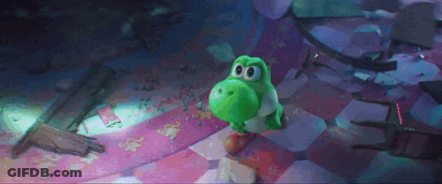 A Green Yoshi Toy Is Standing On A Checkered Floor . GIF