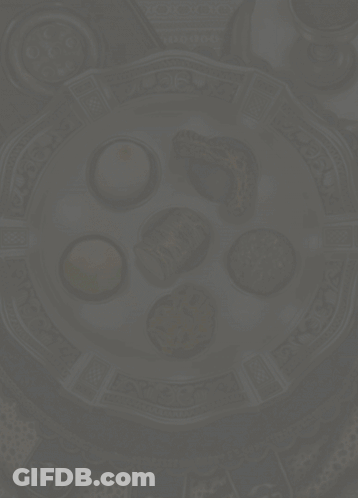 A Greeting Card For Happy Pesagh With A Plate Of Food GIF