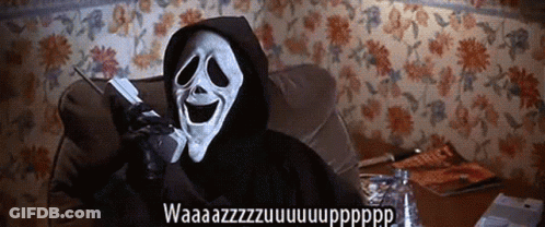 A Grim Reaper Is Sitting On A Couch Talking On A Phone GIF