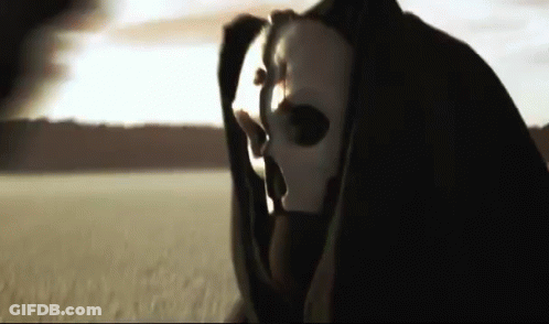 A Grim Reaper Is Wearing A White Mask And A Black Cape GIF