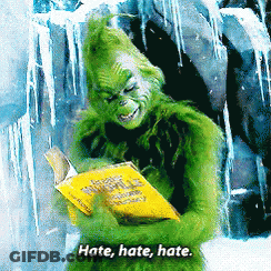 A Grinch Is Reading A Book With The Words Hate Hate Hate GIF