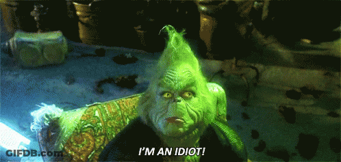 A Grinch With Green Hair Is Sitting In A Chair And Saying I 'M An Idiot GIF