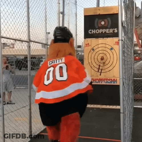 A Gritty 00 Mascot Is Standing In Front Of A Chopper 'S Target GIF