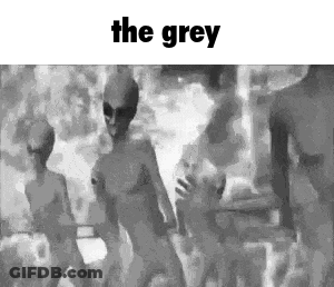A Group Of Aliens Are Dancing In A Black And White Photo With The Words `` The Grey '' Above Them . GIF