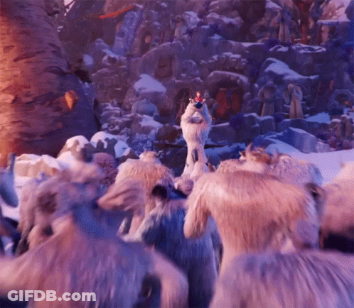 A Group Of Animals Are Standing In The Snow And One Of Them Has A Crown On Its Head . GIF